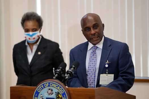 George Miller, president of Loretto Hospital, speaks after five frontline health care workers receive the COVID-19 vaccination at Loretto Hospital in Chicago on Dec. 15, 2020. Mayor Lori Lightfoot looks on. (Jose M. Osorio/ Chicago Tribune)